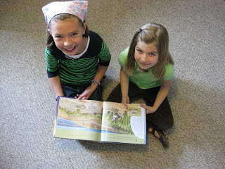 Fourth grader Eva J and first grader Julia C read A Place for Birds
